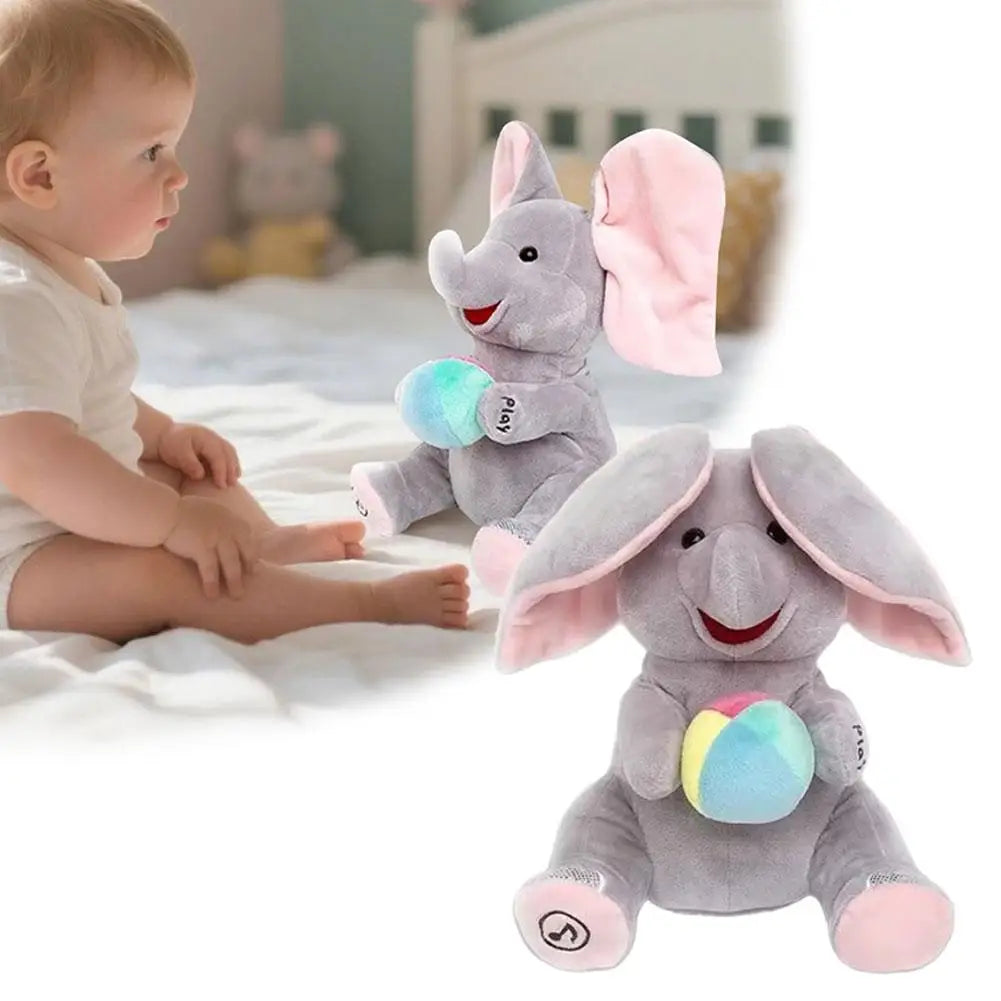 A gray elephant plush toy with pink ears and a colorful ball, sitting next to a baby.