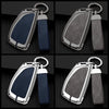 A set of durable zinc alloy and leather car key cases in dark blue and black.