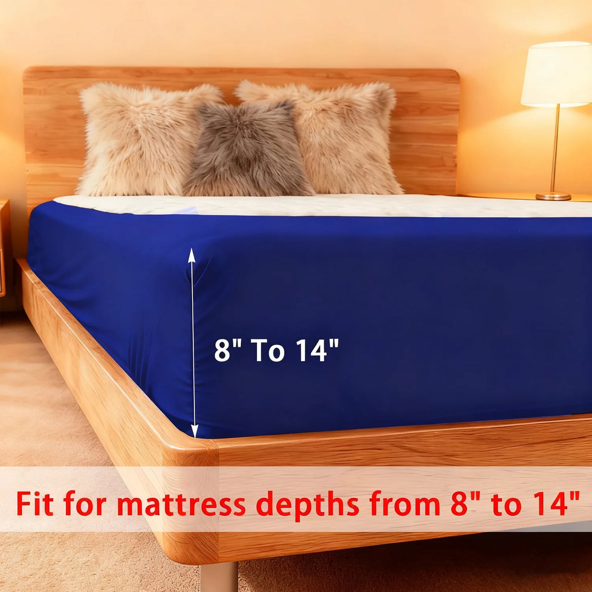 A blue stretch-fit box spring cover is shown on a wooden bed frame with fluffy pillows.