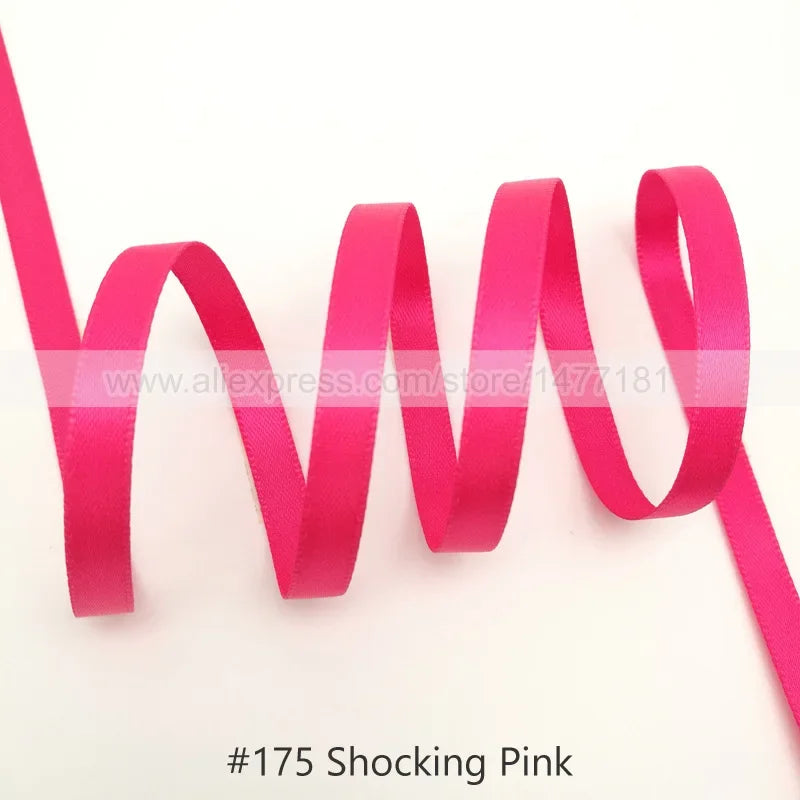 Pink satin ribbon coiled in a wavy shape