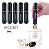 A set of five black glass perfume spray bottles with gold accents and a hand holding one bottle over a pink glass perfume bot