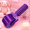 A purple detachable diamond painting roller tool is shown on a pink surface next to a pink rabbit and clear acrylic box.