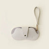 A light beige retro lychee pattern PU leather glasses case with a gold-tone strap.