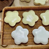A collection of soft, squeezable star-shaped stress relief toys in pale yellow and white are arranged in a woven basket.