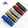 A collection of ten harmonica keys in various colors and finishes displayed on a white surface.