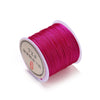 Spool of magenta nylon macramé cord for jewelry making