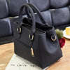 A black vintage PU leather tassel shoulder bag with a crossbody strap resting on a wooden surface.