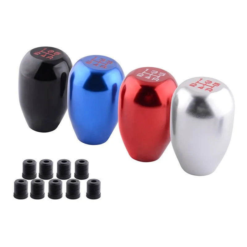 Five colored aluminum gear shift knobs with adapters shown in various colors