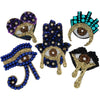 A collection of sparkling beaded rhinestone patches featuring eye designs in purple, blue, and gold tones.