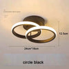 A black ring LED ceiling light fixture with a circular design and a white glow.