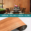 Roll of self-adhesive wood grain wallpaper in a warm brown tone.
