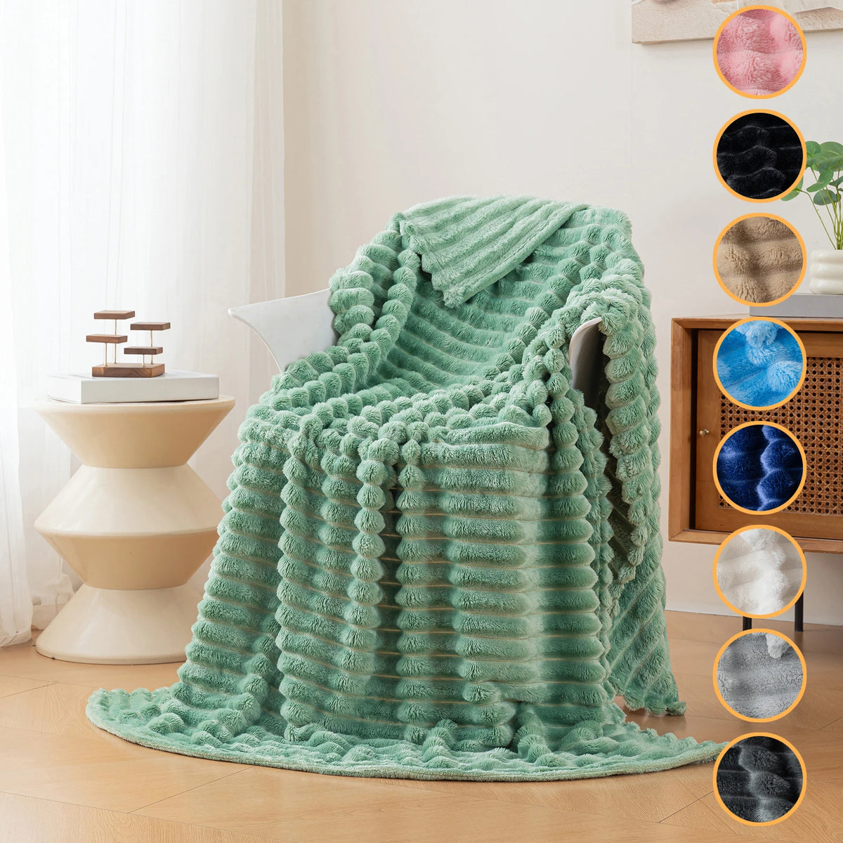 A teal brushed flannel throw blanket draped over a chair in a bright room.