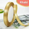 Roll of gold-edge satin ribbon for crafts and decor shown next to a green citrus fruit.