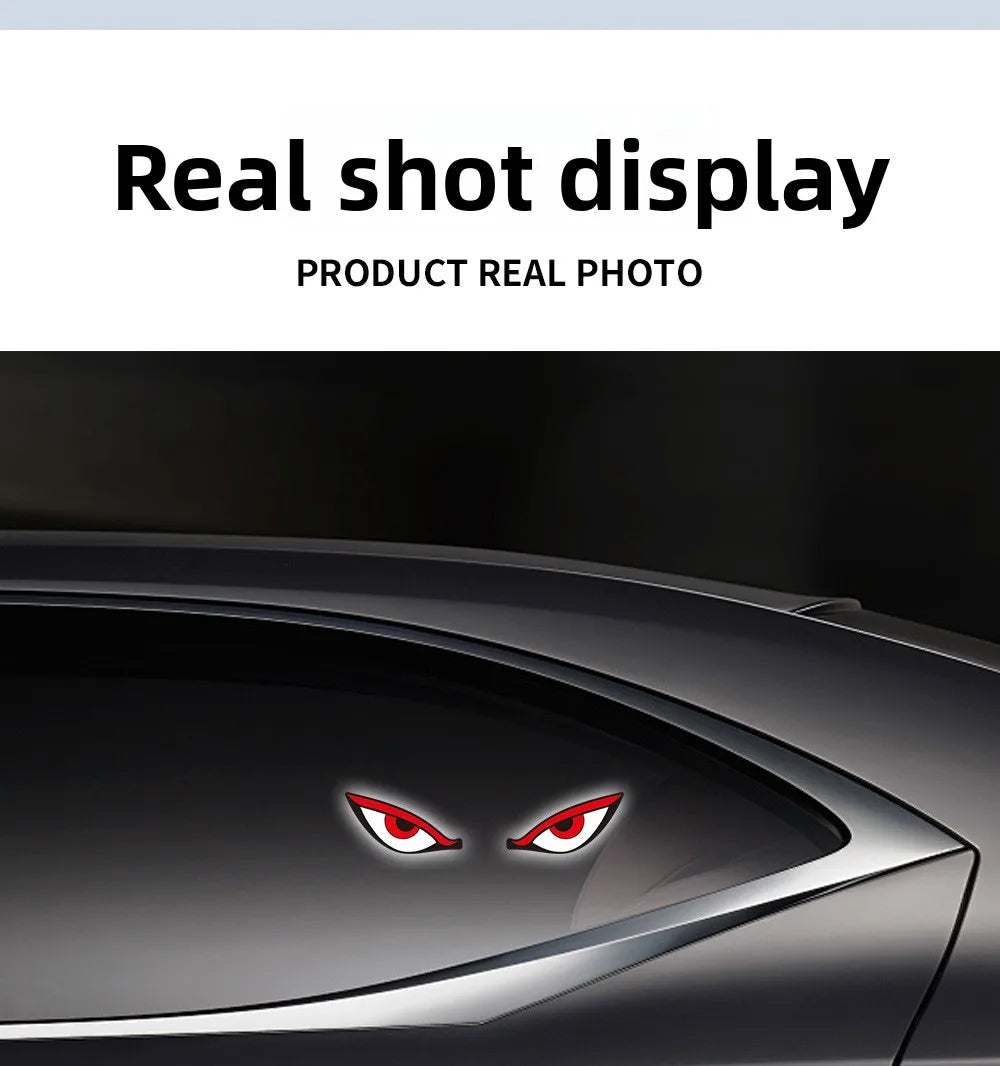 Close-up of a red demon eye LED decal applied to the side window of a dark car.