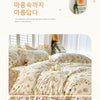 A light floral patterned duvet cover set displayed on a bed with sheer curtains.