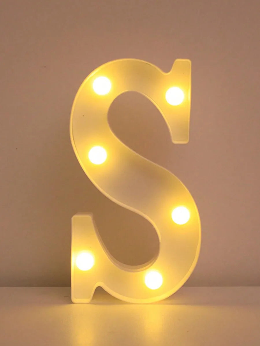 A glowing white LED letter night light shaped like the letter S, featuring multiple illuminated dots.
