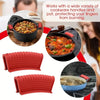 Two red silicone pan handle covers protecting fingers from burning on cookware.