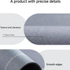 Close-up view of a grey bath mat showing texture, smooth edges, and non-slip rubber base.