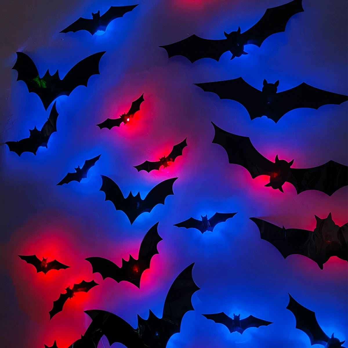 Black bat silhouettes with red and blue LED glow against a dark background for Halloween decor