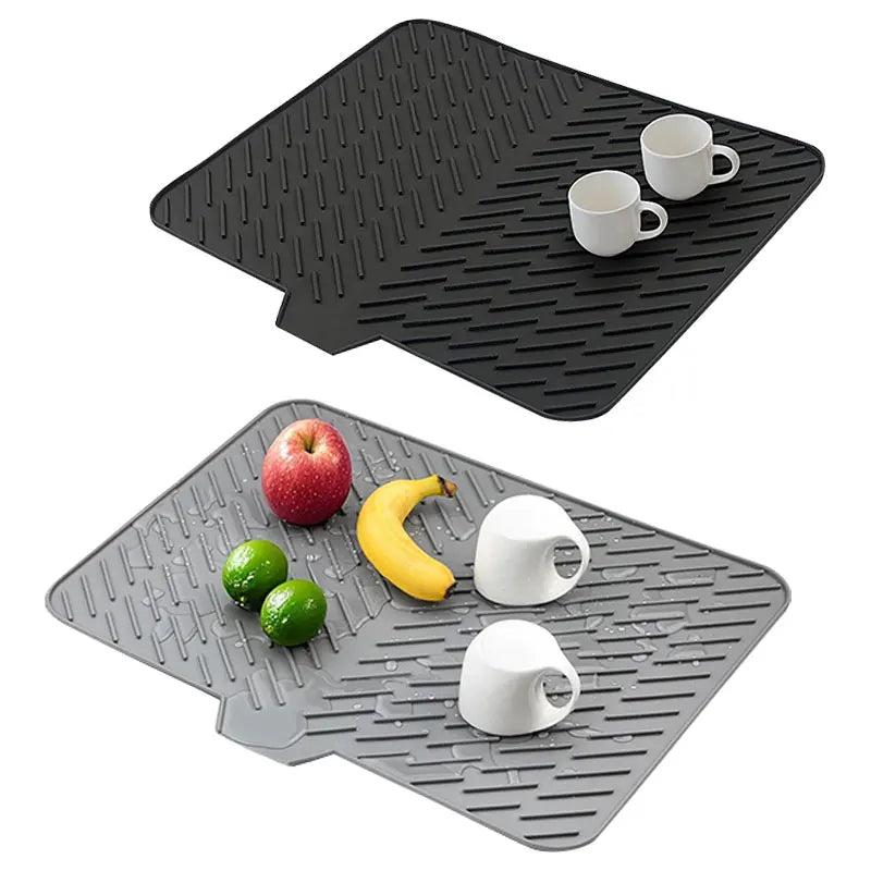Black silicone dish drying mat with a built-in drain lip and two white mugs placed on it.