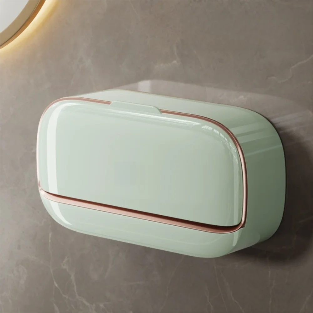 A rectangular, light mint green wall mounted waterproof soap dish with a copper trim is displayed on a gray surface.