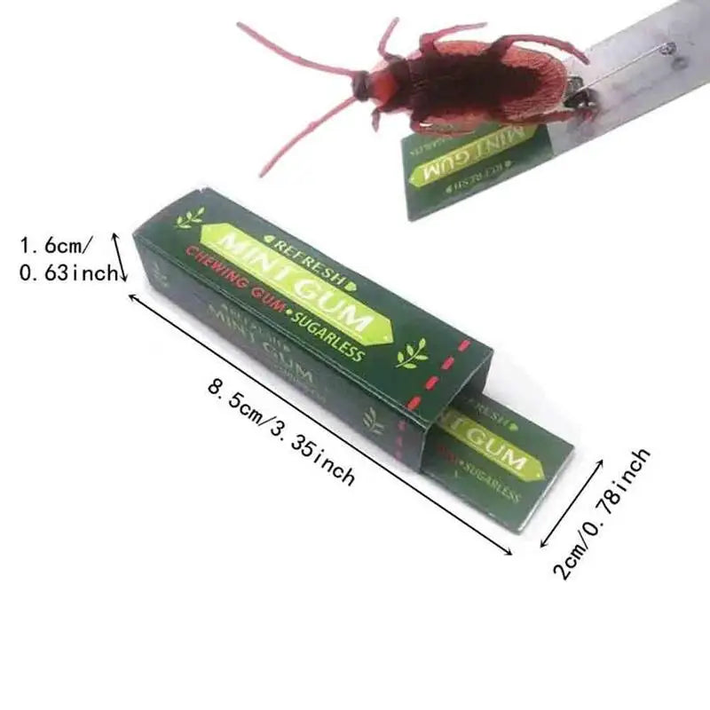 A realistic cockroach prank gum toy attached to a metal strip.