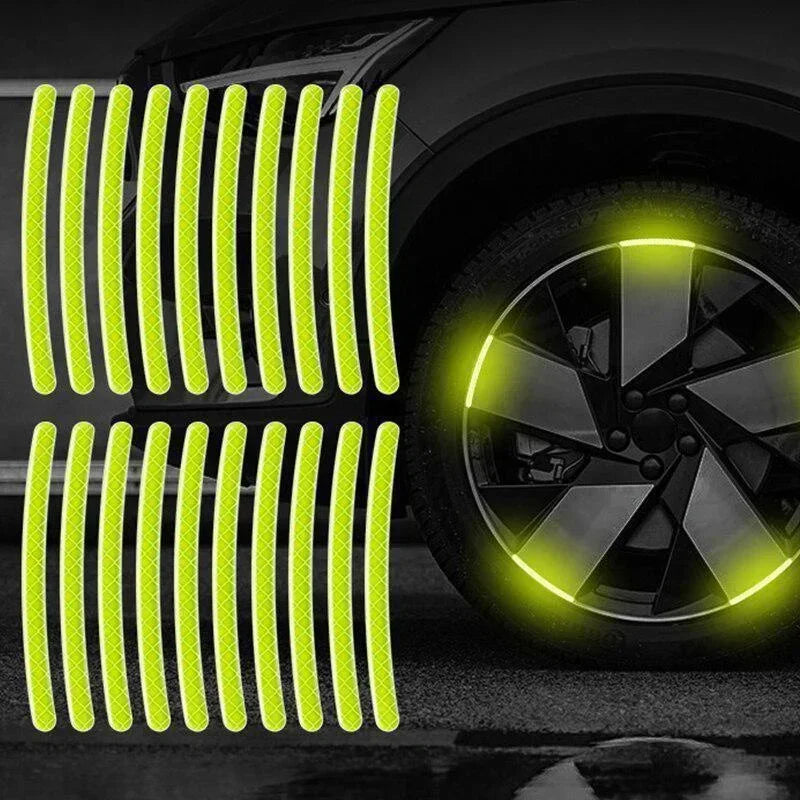 A set of bright yellow reflective vertical strips and a glowing wheel hub sticker on a car tire.