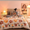 A cozy double-sided velvet warm quilt blanket is displayed on a bed with soft lighting.