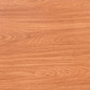 Close-up of warm reddish-brown wood grain vinyl flooring tiles.