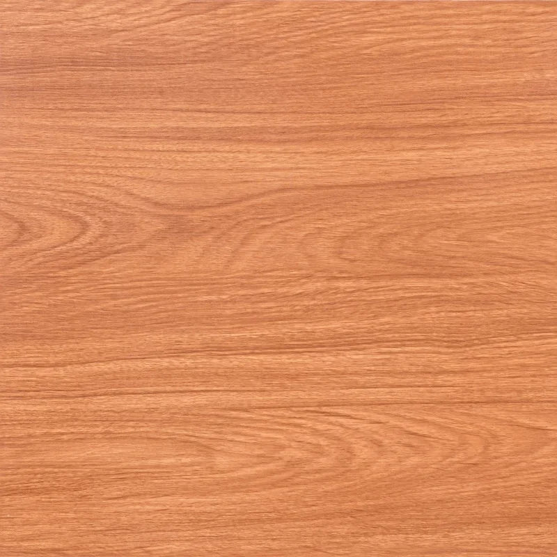 Close-up of warm reddish-brown wood grain vinyl flooring tiles.