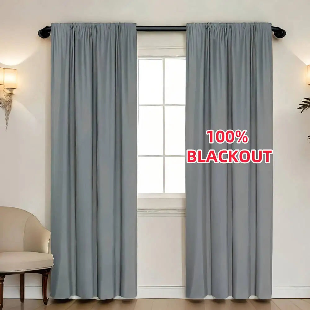 Gray blackout curtain panel hanging in a window frame.