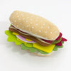 A felt burger and sandwich food play set featuring a bun, meat, lettuce, and tomato layers.