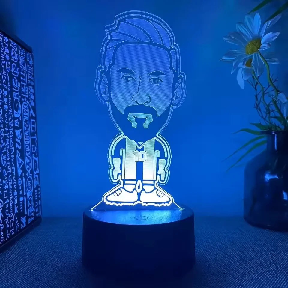 A glowing blue 3D illusion sports night light featuring a male face with a beard and a number 10 on a dark base.