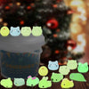 A collection of glow-in-the-dark kawaii animal squishy toys in various colors and shapes displayed in a jar.