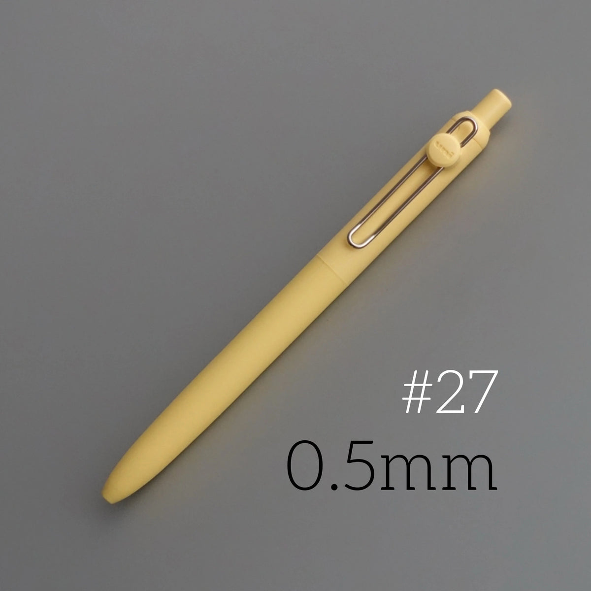 A yellow Uni ZENTO quick-dry gel pen is shown diagonally against a gray background, with the size marked as 0.5mm and item nu