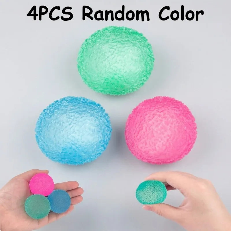 Four random colored soft textured stress balls are shown, some in a hand.