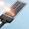 A black solar charging panel is angled towards the sun, demonstrating light energy charging.