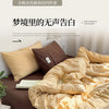 A set of four striped cotton duvet covers displayed on a bed with pillows and bedding.