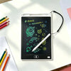 A portable LCD drawing tablet displaying colorful astronaut and space-themed icons on a white desk.