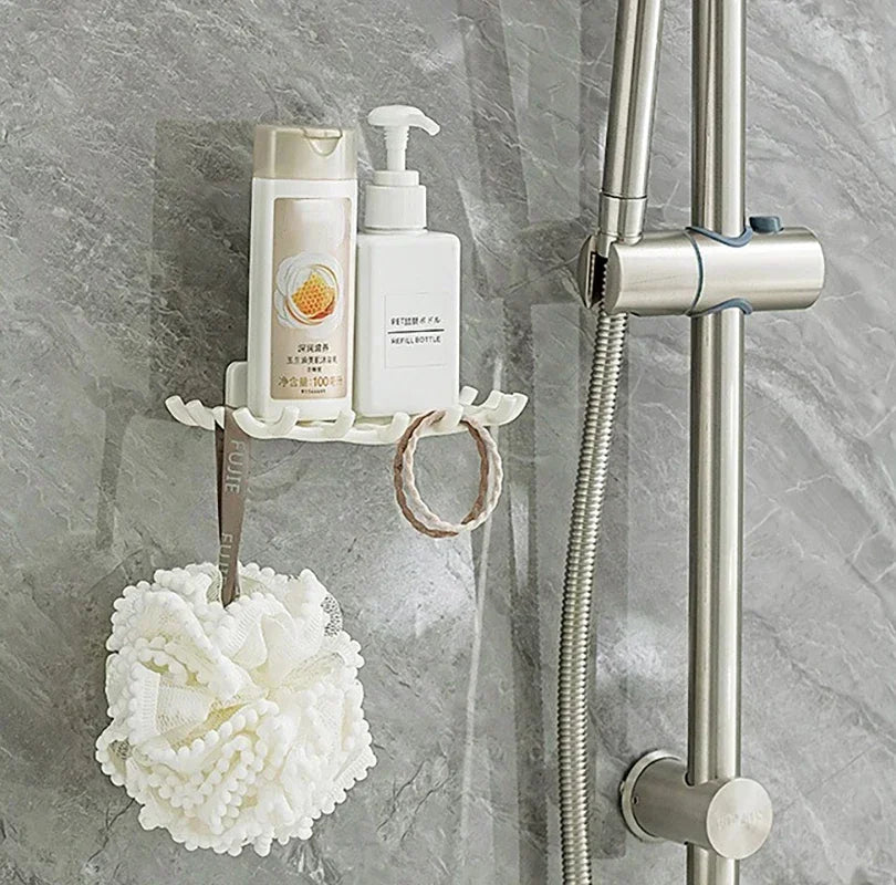 A wall-mounted soap dish with drainage featuring a white bottle and a decorative white pom-pom.