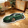 A green Porsche sports car shaped non-slip rug lying on a light wooden floor.