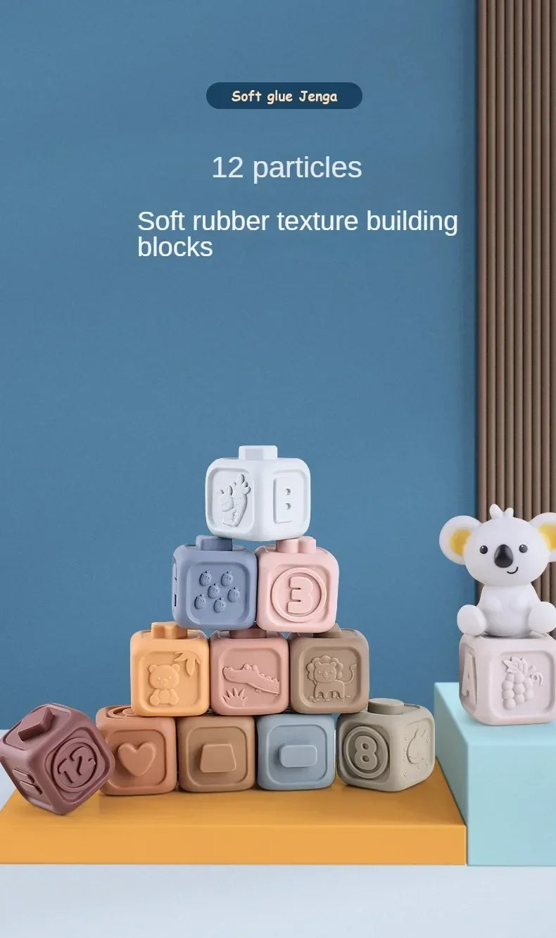 A stack of 12 soft silicone Jenga-style building blocks in various pastel colors on a wooden surface.