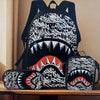 A set of black backpacks featuring a graphic print of a shark's open mouth and teeth.