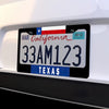 A black license plate frame displaying a Texas flag design and the text 33AM123.