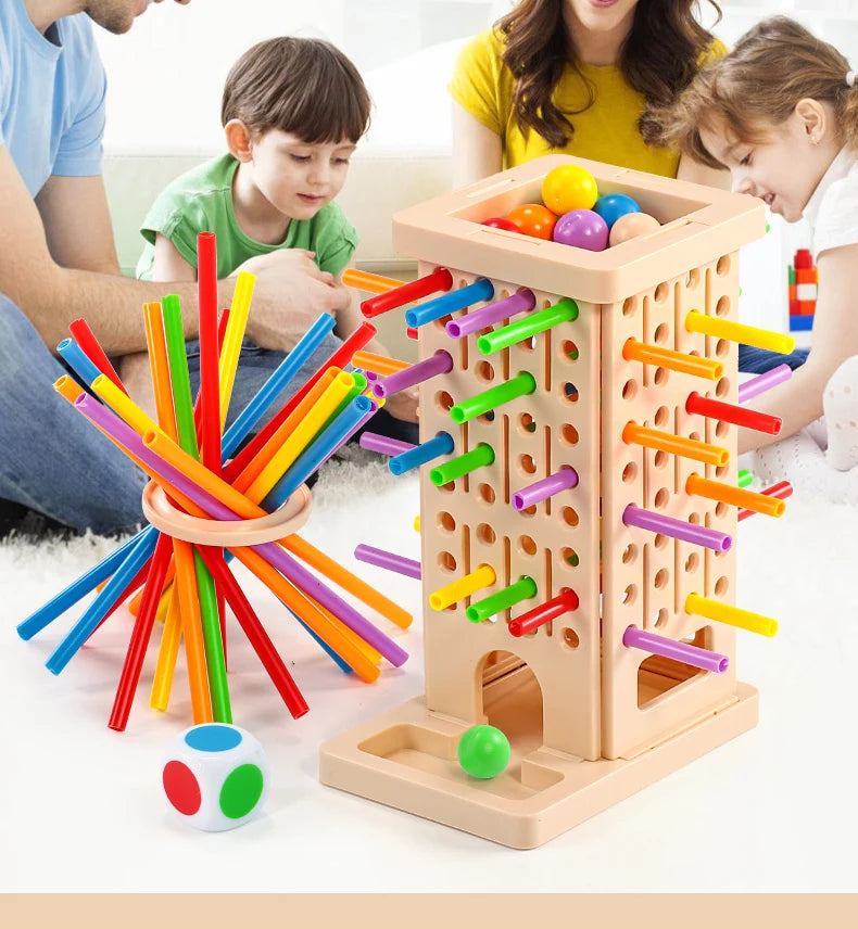 A wooden pick-up sticks board game with colorful sticks and balls is being played by a family.