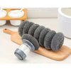 A set of grey press dish brushes with built-in soap dispensers displayed on a wooden board.