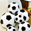 A collection of white and black football plush pillows displayed on a light-colored surface.