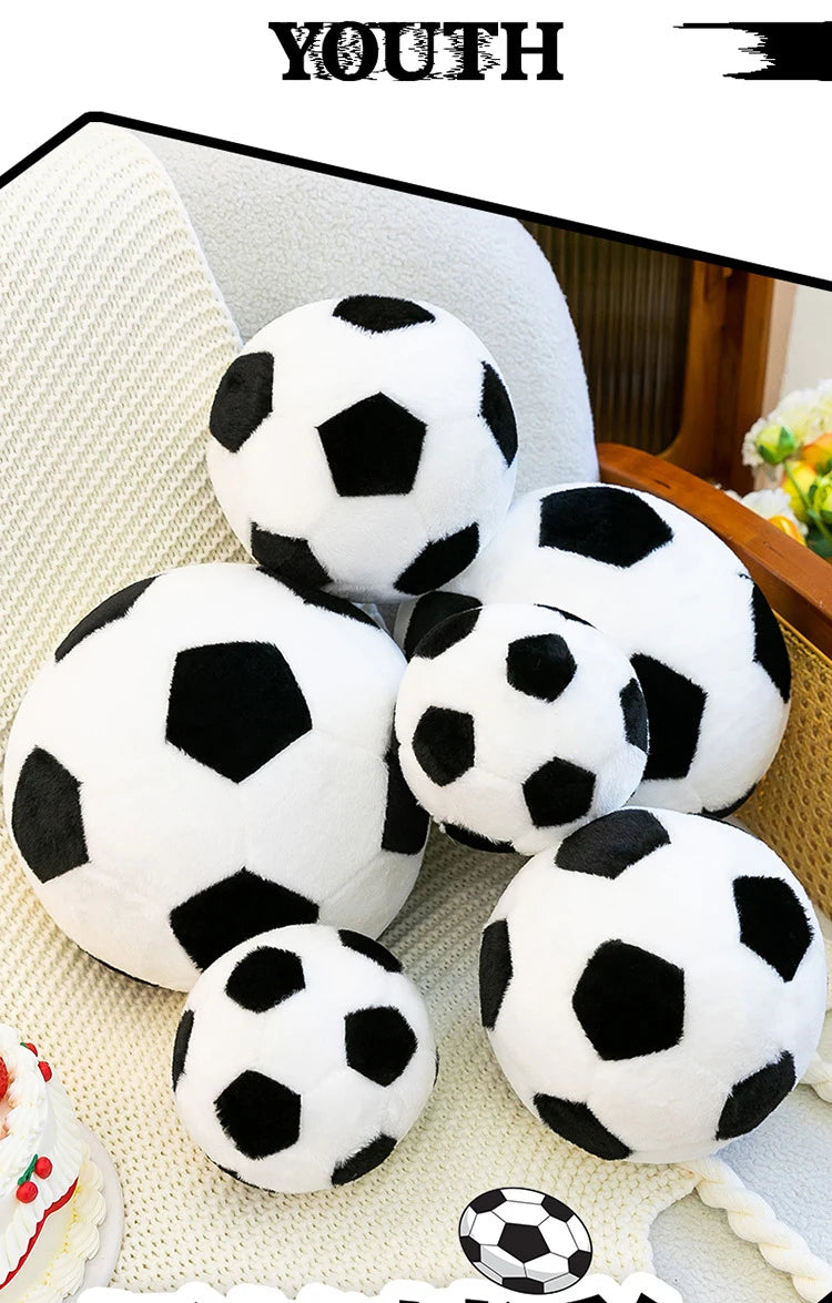A collection of white and black football plush pillows displayed on a light-colored surface.
