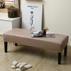 A beige waterproof PU stretch bench cover is displayed on a wooden bench with a minimalist drawing of a figure on the wall.
