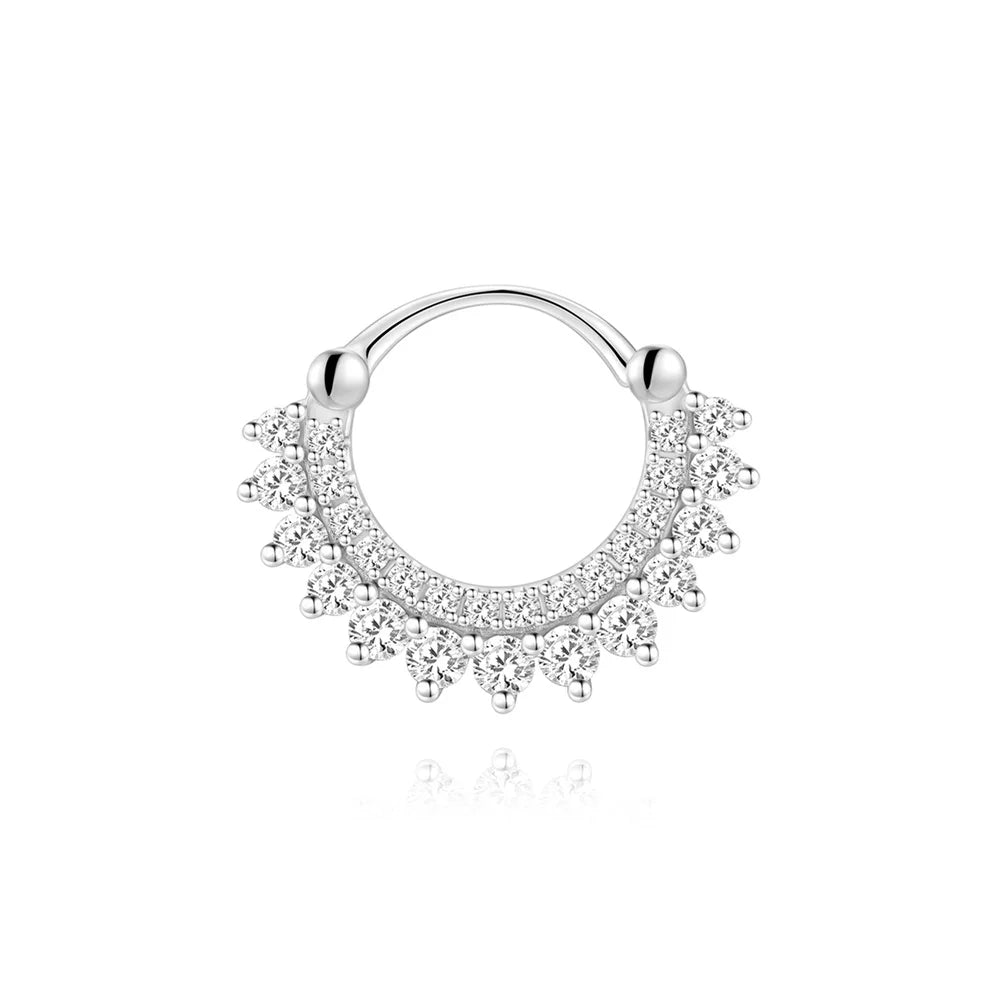 Silver bowknot stud earrings featuring a halo of small clear stones